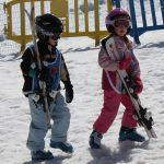 5 year olds carrying their own skis